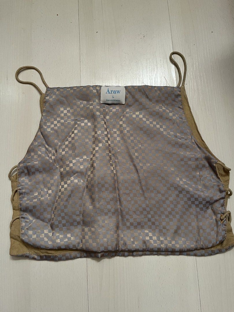 Araw Checkered Bintana Top (Category: Sleeveless) located in Makati City. Submitted by momentaryarchives (Listing ID 1424417758, Image 3). Description: - Unique checkered pattern - Neutral color palette - Thin straps - Reversible design (solid tan on the other side) - Side ties for adjustable fit - Brand tag visible Rfs: decluttering Can fit a S-M for a loose fit Design is archival .