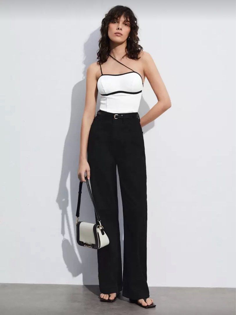 Black and White Color Block Asymmetric Top (Category: Sleeveless) located in Manila. Submitted by your_angel (Listing ID 1424420127, Image 2). Description: - White top - Black trim detail - Thin straps - Flattering fit - Pairs well with high-waisted bottoms - Dress up or down - A versatile wardrobe essential.