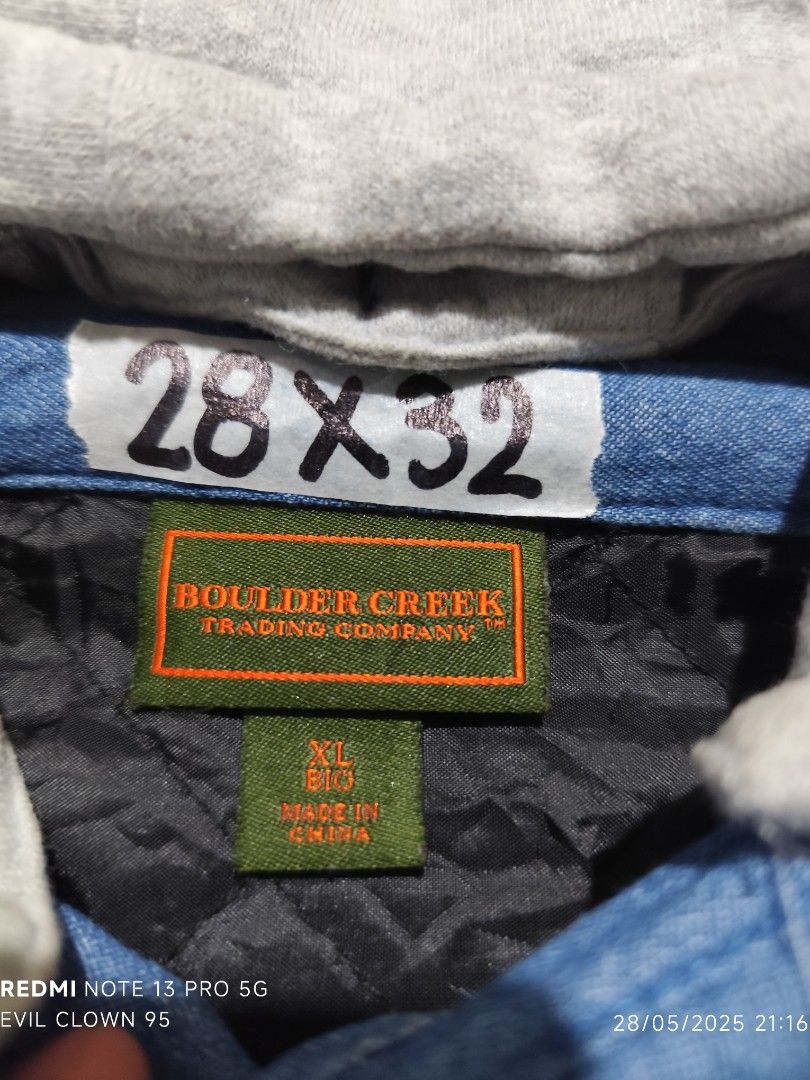 Boulder Creek Hooded Denim Jacket XL (Category: Coats, Jackets and Outerwear) located in Baguio. Submitted by FRANKLIN (Listing ID 1424505507, Image 3). Description: Boulder Creek denim jacket with a gray hood. Features a button-down front, two chest pockets, and a quilted black lining. The jacket is an XL size. The buttons are branded with "Boulder Creek". The jacket has a drawstring on the hood..