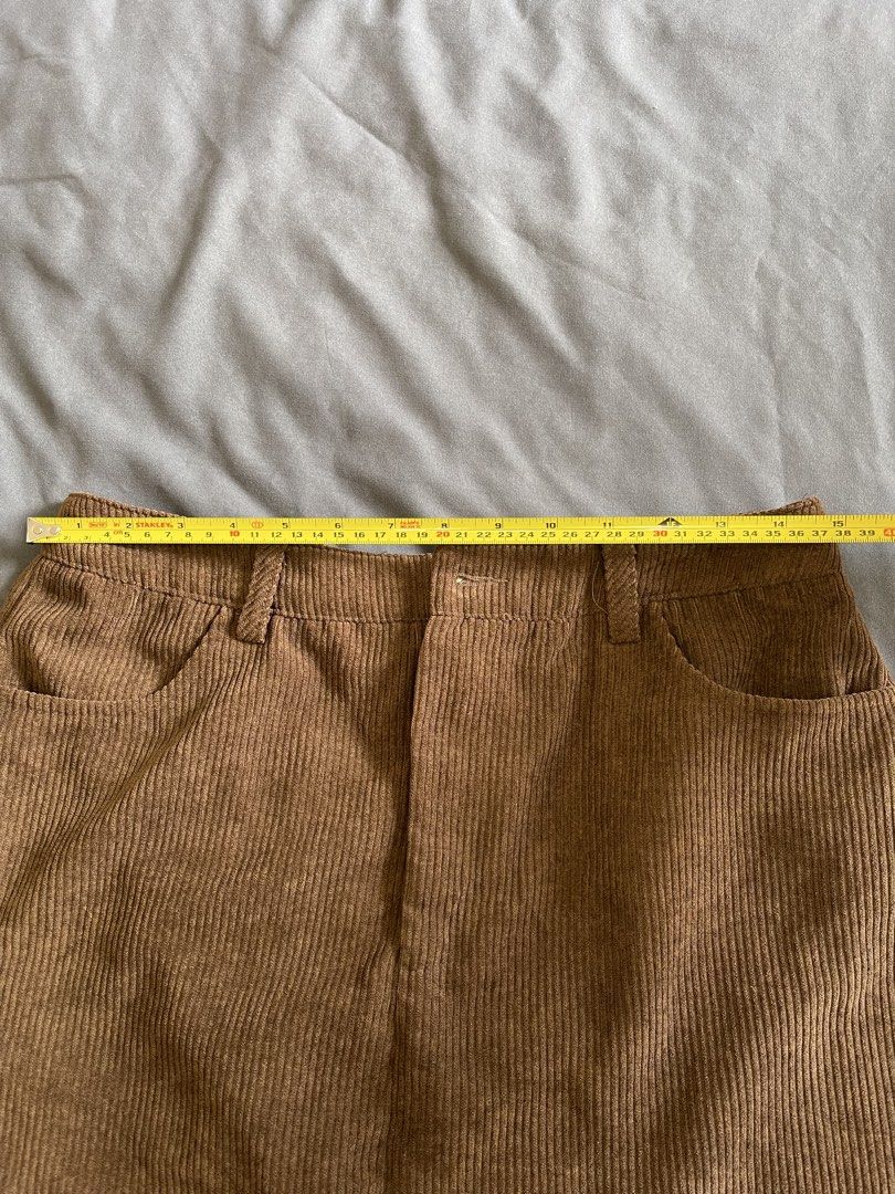 Brown Corduroy Skirt (Category: Skirts) located in Quezon City. Submitted by litol_bee (Listing ID 1424515878, Image 2). Description: - Brown corduroy skirt - Classic design - Two front pockets - Button closure - Versatile for various outfits.