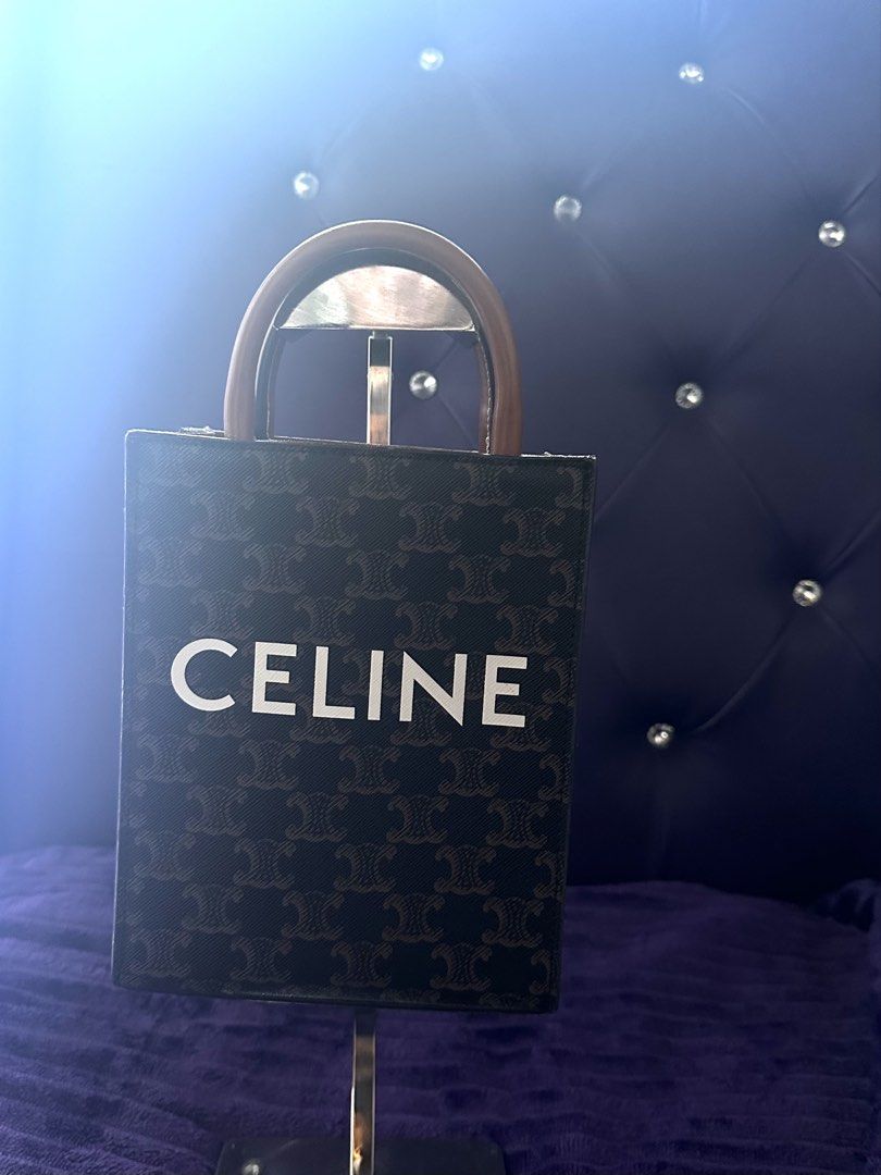 Celine Vertical Cabas Bag (Category: Luxury Bags & Wallets) located in San Jose. Submitted by we.luv.u (Listing ID 1424521297, Image 3). Description: Celine Vertical Cabas bag with a brown leather handle and a detachable shoulder strap. The bag features the Celine logo in white on the front. The interior is brown. The bag has a brown and black strap with gold hardware. The bag has a brown leather handle with white stitching. LxWxH : 8x2x6 inches.