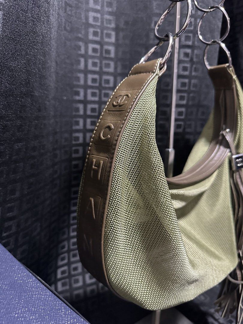 Chanel Hobo Bag with Chain Strap (Category: Luxury Bags & Wallets) located in Atok. Submitted by fullroom.dgs (Listing ID 1424450638, Image 3). Description: - Authentic Chanel hobo bag - Unique olive green mesh design - Brown leather trim - Stylish chain strap - Features a tassel detail - Chanel logo embossed on the side - Spacious interior - Comfortable shoulder strap.