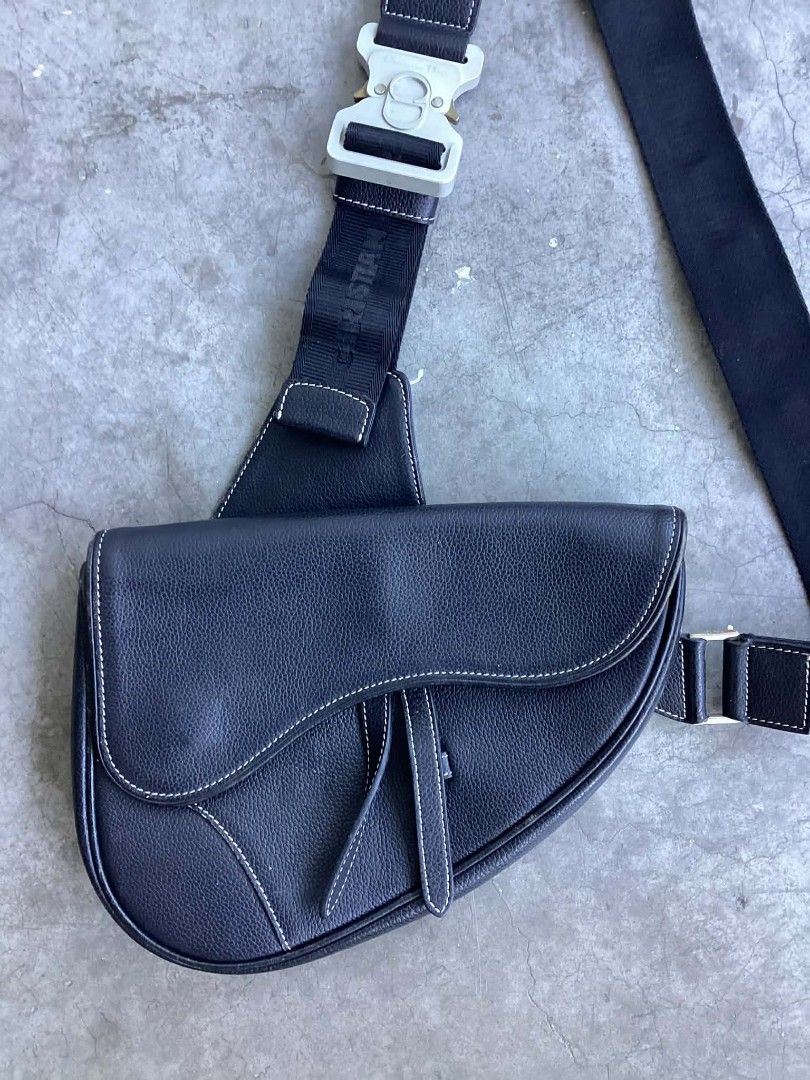 Christian Dior Saddle Sling Bag (Category: Luxury Bags & Wallets) located in Cavite. Submitted by benta_bounce (Listing ID 1424432136, Image 3). Description: - Christian Dior Saddle Sling Bag - Black leather exterior - White stitching detail - Silver-tone buckle - Christian Dior logo strap - Interior zipper closure - 'Made in Italy' label.
