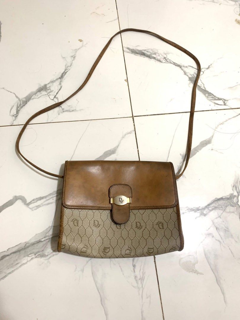 Christian Dior Shoulder Bag (Category: Luxury Bags & Wallets) located in Caloocan City. Submitted by pumarenluc79160 (Listing ID 1424352851, Image 2). Description: - Vintage Christian Dior shoulder bag - Features a brown leather flap and strap - Beige monogram pattern - Interior pocket - Made in France - Magnetic snap closure.
