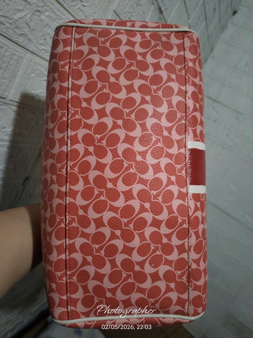 Coach Signature Satchel Handbag (Category: Luxury Bags & Wallets) located in Bulacan. Submitted by dstore4u (Listing ID 1424483065, Image 3). Description: - Authentic Coach handbag - Signature red and white pattern - Dual top handles - Secure zip closure - Central red stripe with Coach logo detail - Light pink fabric lining - Boston bag Second hand, with sign of use manage you expectations .