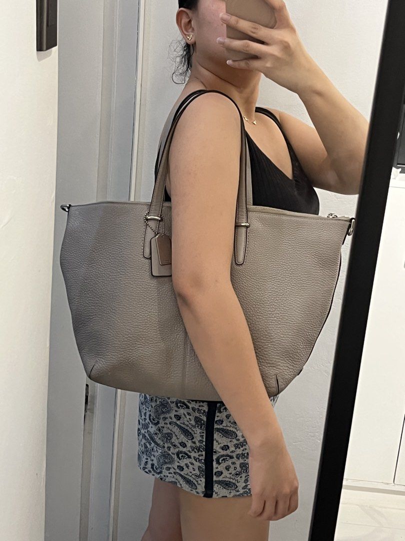 Coach Tote Bag with Shoulder Strap (Category: Luxury Bags & Wallets) located in Bacolod City. Submitted by gin.knee (Listing ID 1424470917, Image 3). Description: - Coach tote bag - Neutral grey color - Detachable shoulder strap - Zip closure - Interior pockets - Coach tag included - Light beige interior lining - Made of leather.