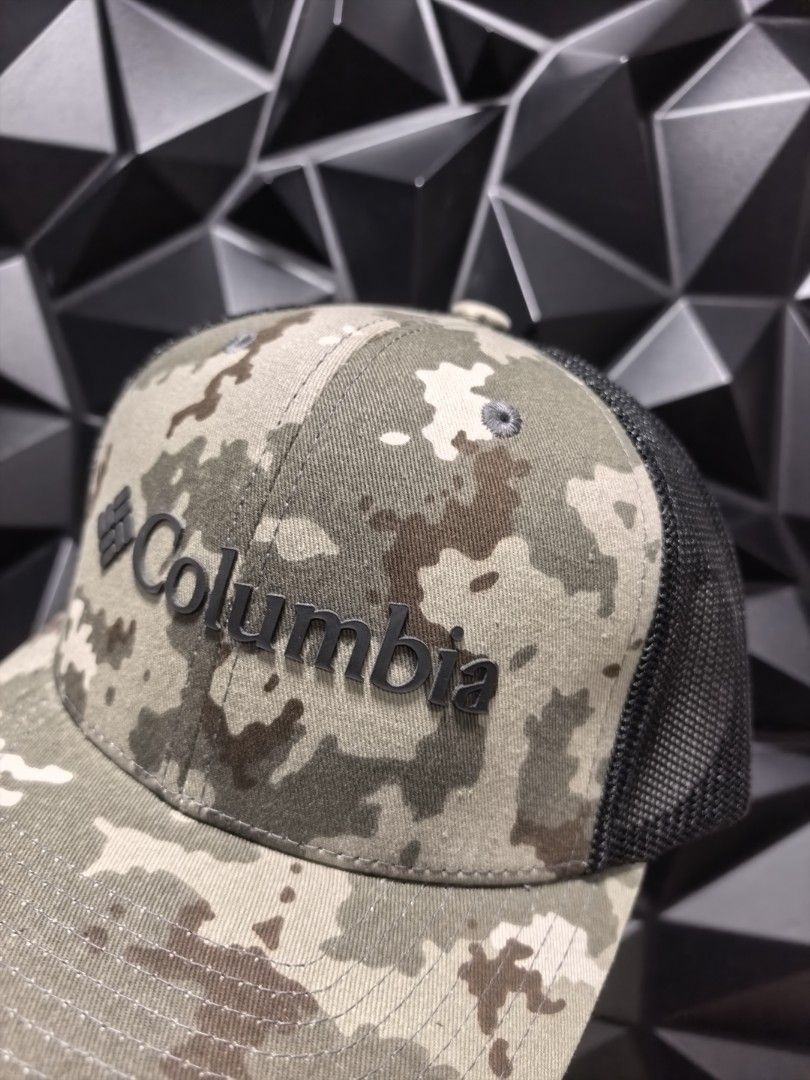 Columbia Camo Trucker Cap (Category: Caps & Hats) located in Bacoor. Submitted by secretsup (Listing ID 1424456334, Image 2). Description: Columbia cap with a camouflage pattern on the front panel and a black mesh back. Features the Columbia logo on the front. The cap has an adjustable strap for a comfortable fit. The size is OS (One Size)..