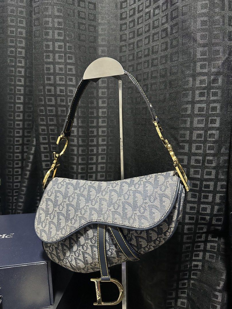 Dior Saddle Bag Oblique (Category: Luxury Bags & Wallets) located in Atok. Submitted by fullroom.dgs (Listing ID 1424450729, Image 1). Description: - Authentic Dior Saddle Bag - Oblique canvas - Navy blue leather strap - Gold-tone hardware - Features iconic 'D' charm - Interior: Christian Dior Paris label, Made in Italy tag with serial number 06-RU-1025.