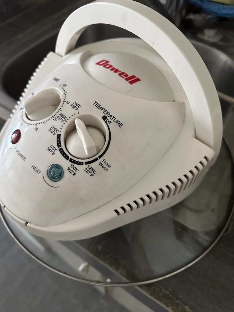 Dowell Halogen Oven (Category: Ovens & Toasters) located in Quezon City. Submitted by khaleesitargaryen_08 (Listing ID 1424385823, Image 1). Description: - Dowell halogen oven - Temperature and time controls - Glass bowl with metal rack - Power and heat indicator lights - Temperature range: 125°F - 482°F - Thaw/wash setting - White body with handle.