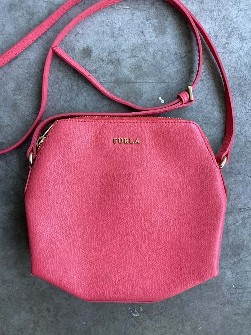 Furla Pink Crossbody Bag (Category: Luxury Bags & Wallets) located in Cavite. Submitted by benta_bounce (Listing ID 1424434350, Image 3). Description: - Authentic Furla crossbody bag - Eye-catching pink color - Gold zipper detail - Adjustable long strap - Interior pocket - Made in Italy, genuine leather - Unique shape.