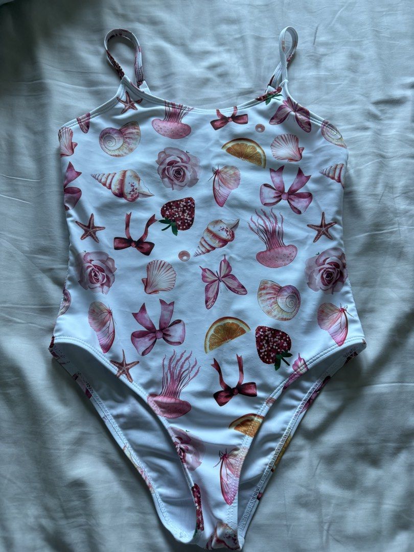 Girls' Swimsuit Size 10Y (Category: Babies & Kids Fashion) located in Taguig. Submitted by macncheese (Listing ID 1424519906, Image 1). Description: - Size: 10Y - Shein - Design: All-over print with seashells, butterflies, strawberries, and bows - Features: Adjustable straps, scoop back - Origin: Made in China.