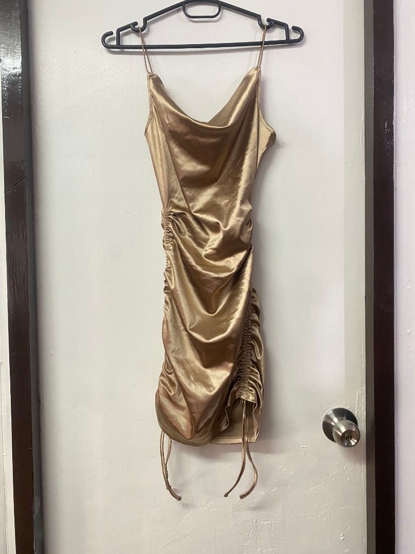 Gold Satin Mini Dress (Category: Dresses) located in Dasmarinas. Submitted by shop.rie (Listing ID 1424426278, Image 1). Description: - Gold satin mini dress - Cowl neckline - Adjustable side ruching - Spaghetti straps - Flattering silhouette - Perfect for special occasions and nights out.