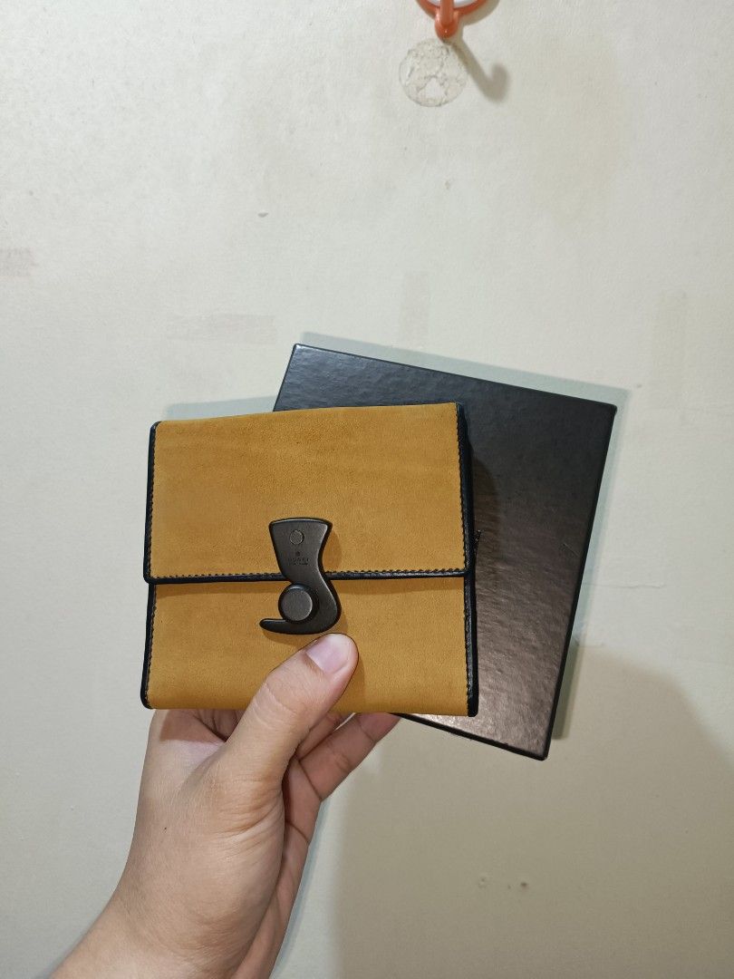 Gucci Leather Wallet (Category: Luxury Bags & Wallets) located in Makati City. Submitted by ivsseyow03 (Listing ID 1424498405, Image 1). Description: - Authentic Gucci leather wallet - Unique clasp design - Tan exterior with black trim - Black leather interior - Multiple card slots and compartments - Includes original box.