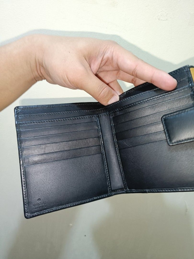 Gucci Leather Wallet (Category: Luxury Bags & Wallets) located in Makati City. Submitted by ivsseyow03 (Listing ID 1424498405, Image 3). Description: - Authentic Gucci leather wallet - Unique clasp design - Tan exterior with black trim - Black leather interior - Multiple card slots and compartments - Includes original box.