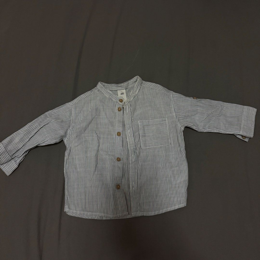 H&M Striped Long Sleeve Shirt (Category: Babies & Kids Fashion) located in Cavite. Submitted by jomspreloved (Listing ID 1424461294, Image 1). Description: - H&M long sleeve shirt - Striped pattern - Mandarin collar - Chest pocket - Button closures (front and cuffs) - Size: 9M - Lightweight fabric - Ideal for casual wear.