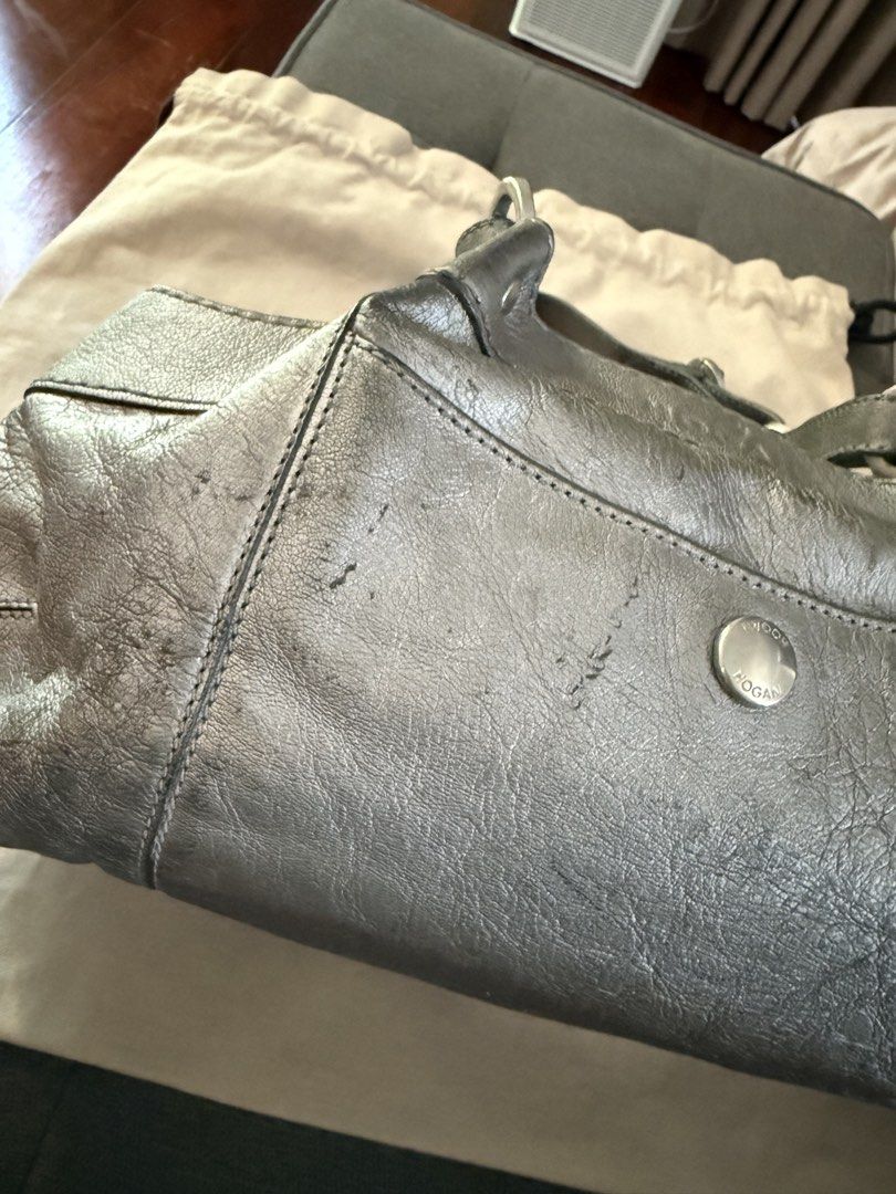 Hogan Metallic Leather Handbag (Category: Luxury Bags & Wallets) located in Makati City. Submitted by jcalmartz (Listing ID 1424365249, Image 3). Description: • ✅ Mini hobo / baguette silhouette • ✅ Double short top handles • ✅ Front flap pocket with snap button • ✅ Pebbled leather with visible natural creasing • ✅ Side buckle hardware detailing.