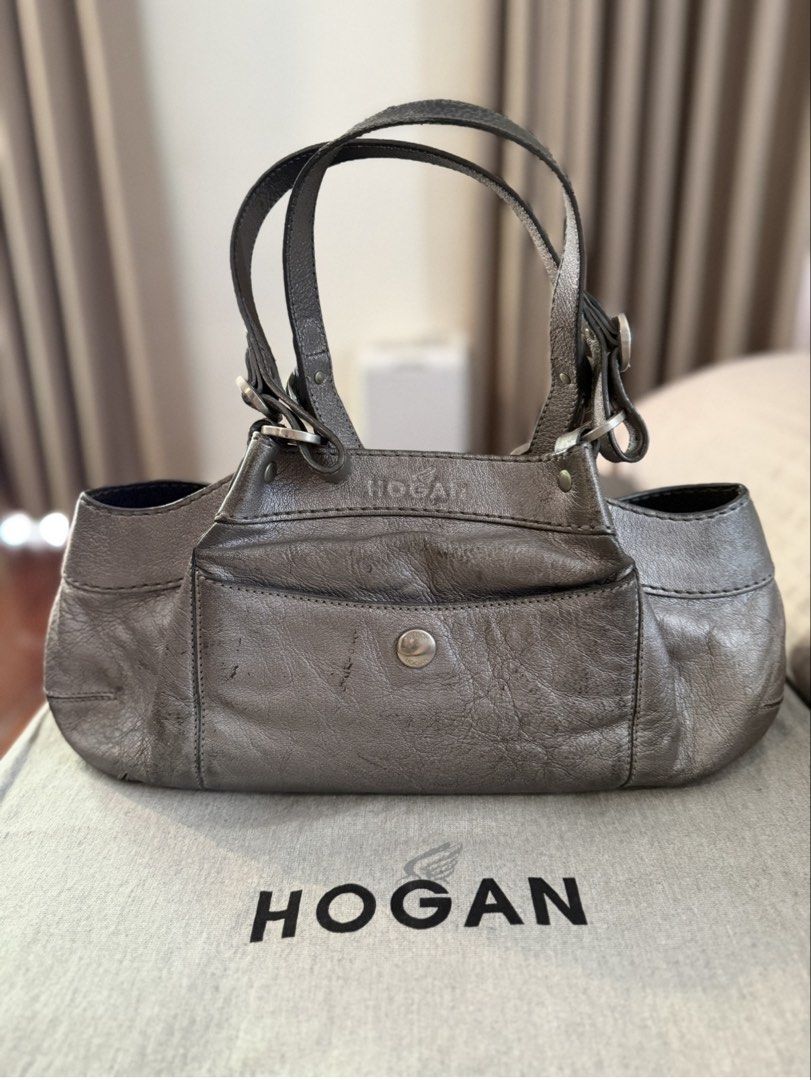 Hogan Metallic Leather Handbag (Category: Luxury Bags & Wallets) located in Makati City. Submitted by jcalmartz (Listing ID 1424365249, Image 1). Description: • ✅ Mini hobo / baguette silhouette • ✅ Double short top handles • ✅ Front flap pocket with snap button • ✅ Pebbled leather with visible natural creasing • ✅ Side buckle hardware detailing.