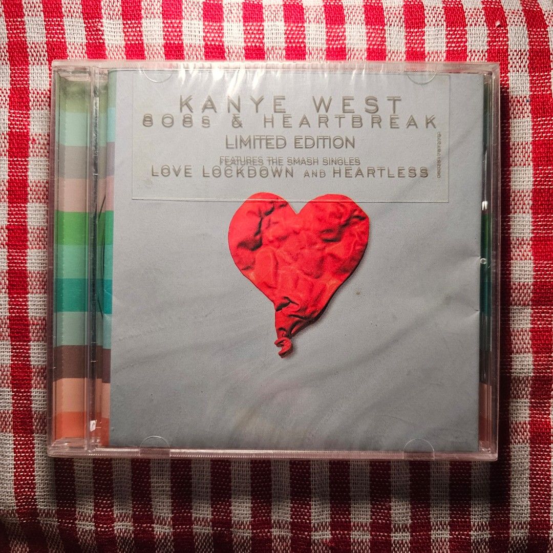Kanye West 808s & Heartbreak Limited Edition CD (Category: CDs & DVDs) located in Quezon City. Submitted by serefrenpaz (Listing ID 1424461055, Image 1). Description: Limited edition CD of Kanye West's album, 808s & Heartbreak. It features the smash singles "Love Lockdown" and "Heartless". The CD is still sealed in its original packaging. The back of the CD case has a colorful striped design. The CD is in a clear plastic case..