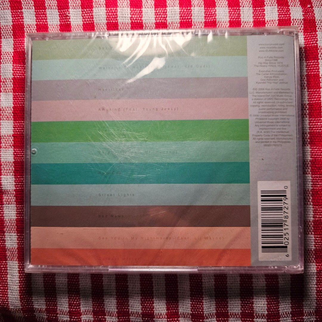 Kanye West 808s & Heartbreak Limited Edition CD (Category: CDs & DVDs) located in Quezon City. Submitted by serefrenpaz (Listing ID 1424461055, Image 2). Description: Limited edition CD of Kanye West's album, 808s & Heartbreak. It features the smash singles "Love Lockdown" and "Heartless". The CD is still sealed in its original packaging. The back of the CD case has a colorful striped design. The CD is in a clear plastic case..