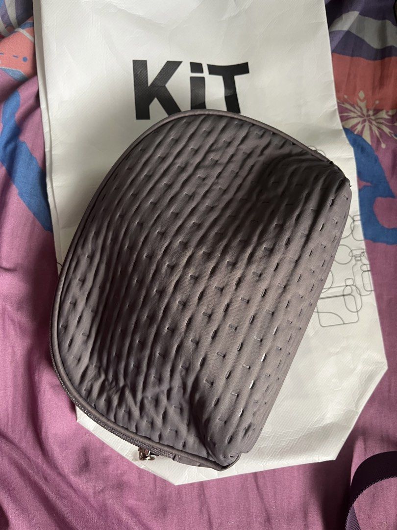 KIT Cosmetic Bag (Category: Purses & Pouches) located in Manila. Submitted by sukkiri_declutter (Listing ID 1424345176, Image 1). Description: - Gray quilted cosmetic bag - Zipper closure - Includes KIT paper bag - Large.