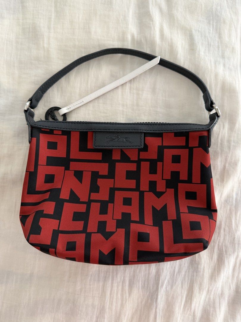 Longchamp Le Pliage LGP Shoulder Pouch Bag (Category: Luxury Bags & Wallets) located in Cabanatuan. Submitted by frugalchic.md (Listing ID 1424346773, Image 1). Description: - Authentic Longchamp Le Pliage LGP shoulder pouch bag - Features a striking red and black pattern - Secure zip closure - Comfortable leather handle - Includes a Longchamp zipper pull - Interior color: Red - Made in France - Size: International One Size.