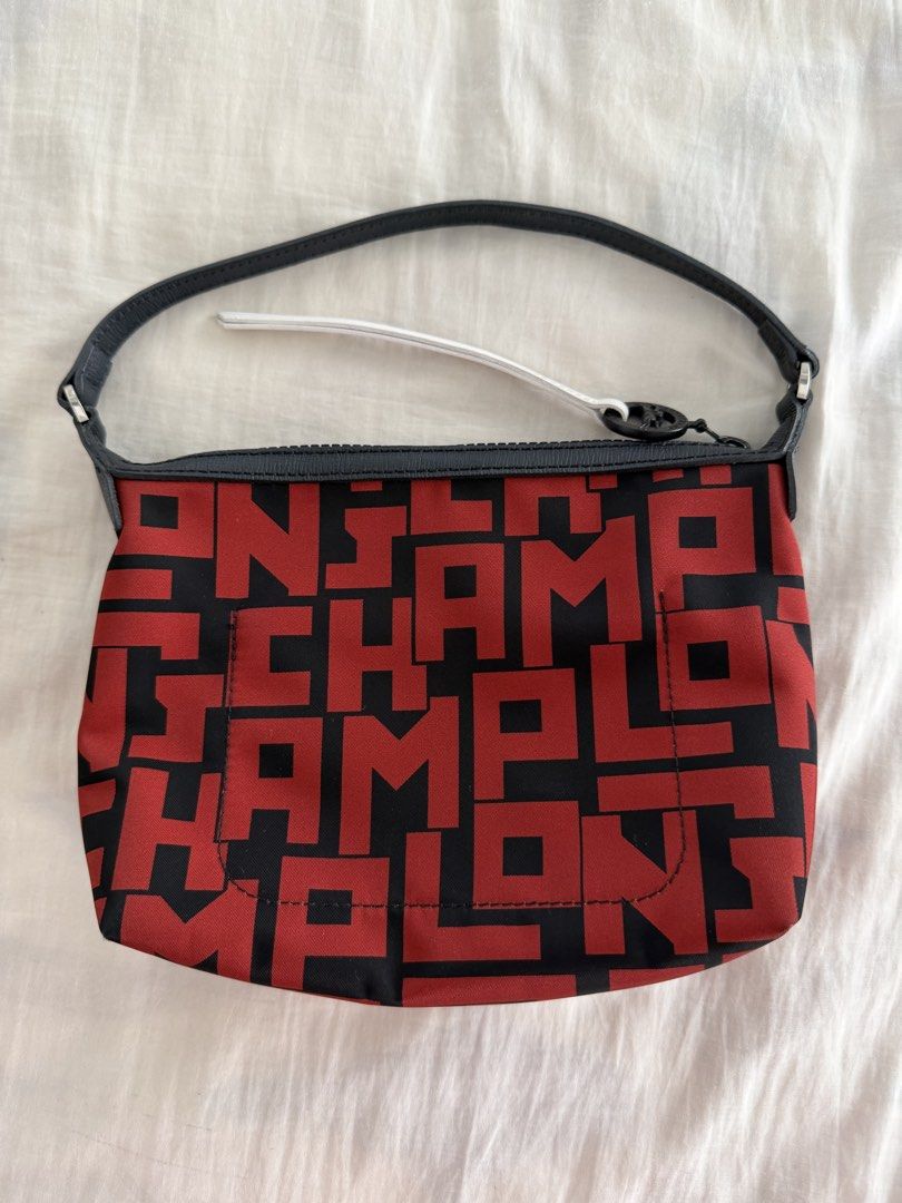 Longchamp Le Pliage LGP Shoulder Pouch Bag (Category: Luxury Bags & Wallets) located in Cabanatuan. Submitted by frugalchic.md (Listing ID 1424346773, Image 2). Description: - Authentic Longchamp Le Pliage LGP shoulder pouch bag - Features a striking red and black pattern - Secure zip closure - Comfortable leather handle - Includes a Longchamp zipper pull - Interior color: Red - Made in France - Size: International One Size.