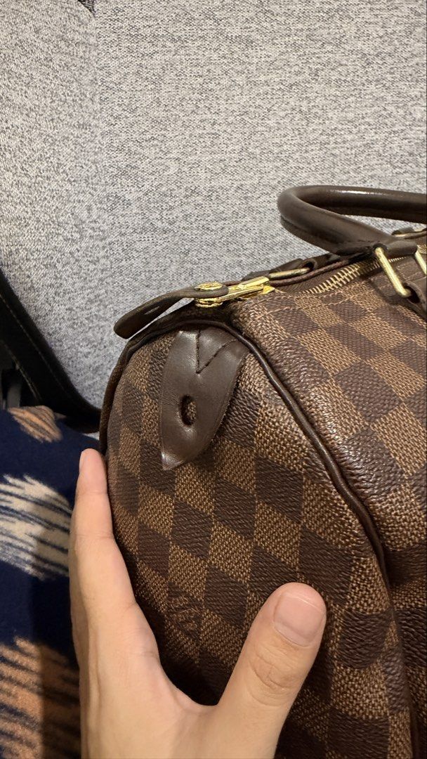 Louis Vuitton Speedy 30 Damier Ebene (Category: Luxury Bags & Wallets) located in Mandaluyong City. Submitted by cdvcdv (Listing ID 1424465434, Image 3). Description: - Guaranteed Authentic Louis Vuitton Speedy handbag - Damier Ebene canvas - Spacious interior with red textile lining - Top zip closure - Rolled leather handles - Gold-tone hardware - Date code: AA3103 - Minor wear on corners and leather trim - Had it bag spa so clean and all good.