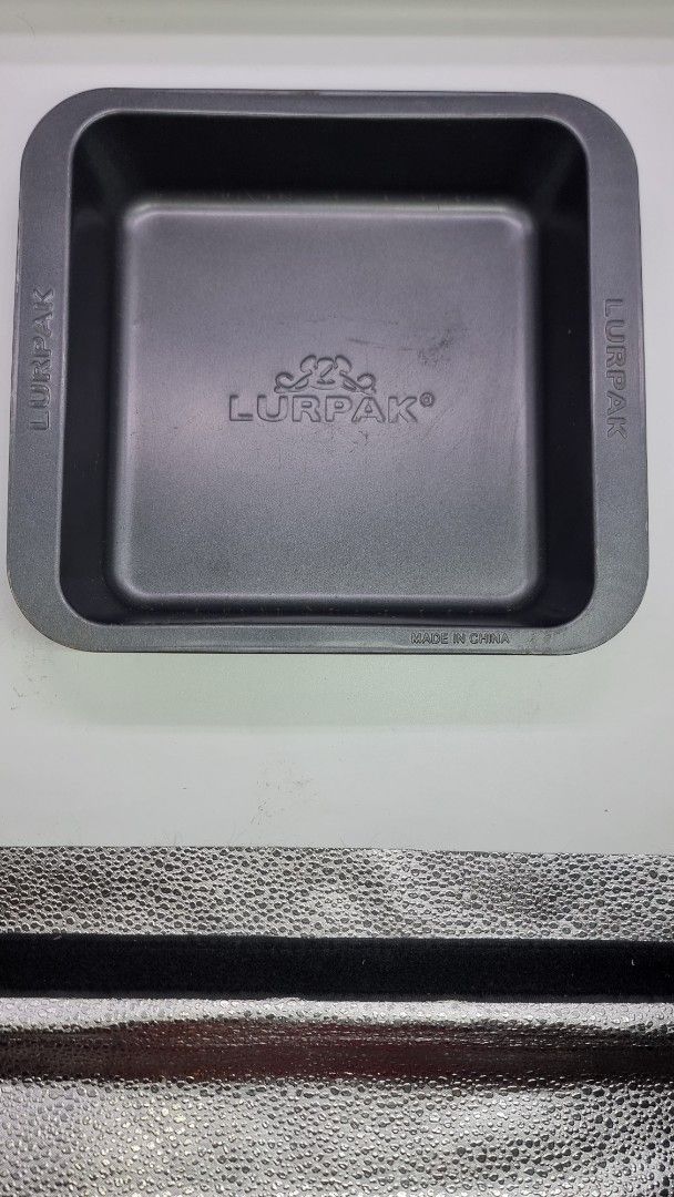 Lurpak Square Baking Pan (Category: Bakeware) located in Marikina City. Submitted by andreah_16 (Listing ID 1424356582, Image 1). Description: - Lurpak branded baking pan. - Size: Approximately 20cm x 20cm. - Material: Metal - Color: Dark gray - Shape: Square with rounded corners - Origin: Made in China.