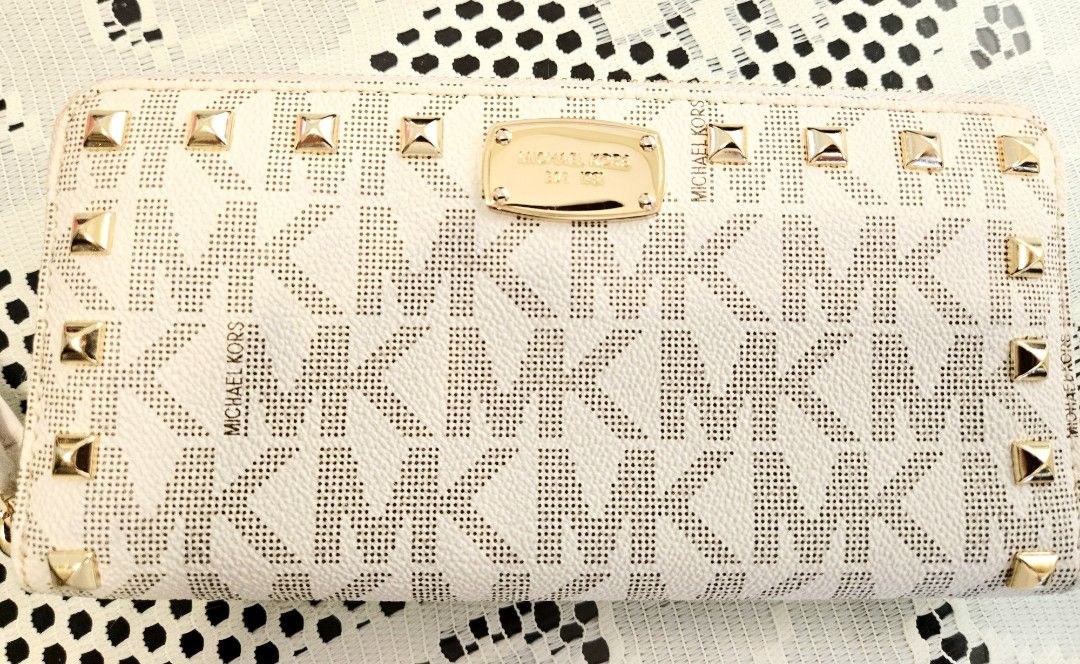 Michael Kors Jet Set Studded ZA Continental Wallet (Category: Luxury Bags & Wallets) located in Santa Rosa. Submitted by unicornshopper (Listing ID 1424377077, Image 1). Description: - Michael Kors wallet - Zip-around closure - Vanilla color with gold-tone studs - MK logo pattern - Multiple card slots and compartments *Price includes shipping fee.