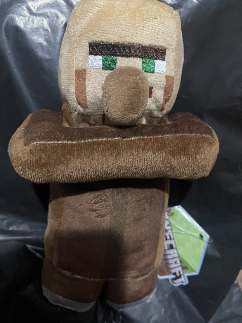Minecraft Villager Plush Toy (Category: Plushies & Soft Toys) located in Muntinlupa City. Submitted by joanofarc1013 (Listing ID 1424423869, Image 1). Description: - Minecraft Villager plush toy - Features iconic villager design - Brown robe and large nose - Includes attached tag - Great for collectors and fans!.