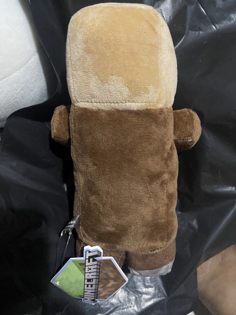 Minecraft Villager Plush Toy (Category: Plushies & Soft Toys) located in Muntinlupa City. Submitted by joanofarc1013 (Listing ID 1424423869, Image 2). Description: - Minecraft Villager plush toy - Features iconic villager design - Brown robe and large nose - Includes attached tag - Great for collectors and fans!.