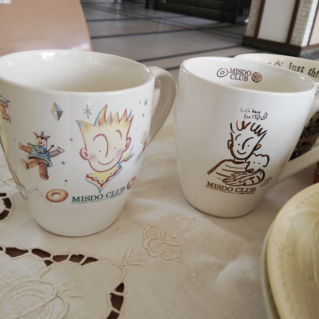 Misdo Club Mugs (Category: Coffee & Tea Tableware) located in Mandaluyong City. Submitted by diynanay (Listing ID 1424522163, Image 1). Description: - Set of two Misdo Club mugs - Features: - Mug 1: Cartoon character with yellow collar and clown - Mug 2: Cartoon character holding a teddy bear - Includes Misdo Club logo - Ideal for coffee, tea, or as a collectible item 300 each 500 for both.