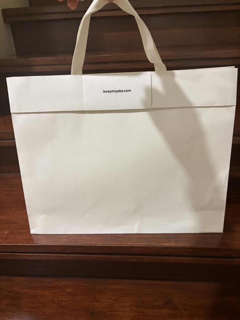 Original Issey Miyake Paper Bag large (Category: Tote Bags) located in Taguig. Submitted by ellejay8 (Listing ID 1424454364, Image 3). Description: - Authentic Issey Miyake paper bag - Features a white exterior - Brand name printed on the front - Sturdy handles - Perfect for gifting or as a stylish accessory.