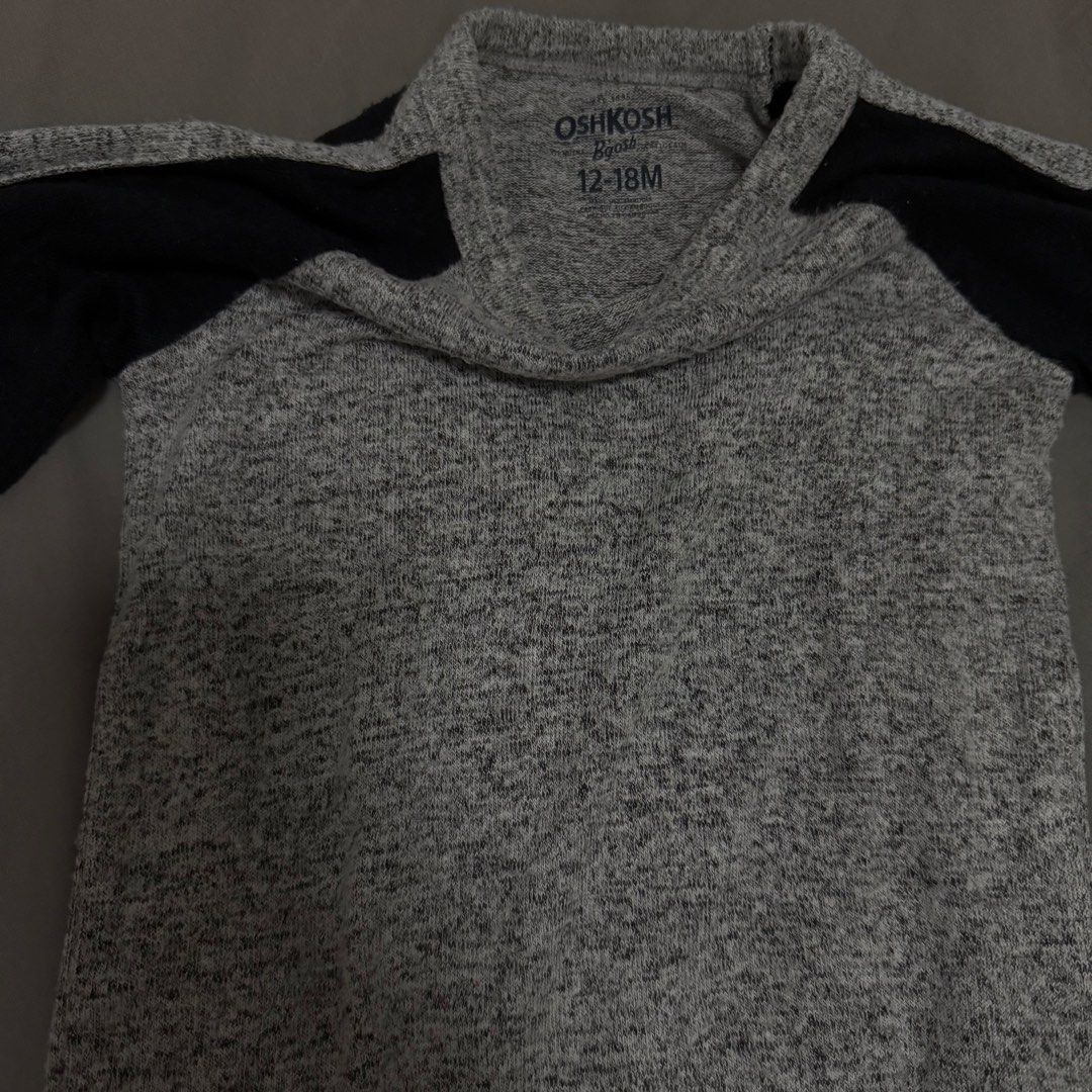 OshKosh B'gosh Gray and Black Sweater (Category: Babies & Kids Fashion) located in Cavite. Submitted by jomspreloved (Listing ID 1424460276, Image 2). Description: - OshKosh B'gosh sweater - Gray body with black sleeves - Crew neck - Long sleeves - Size: 12-18 months - Soft, textured material.