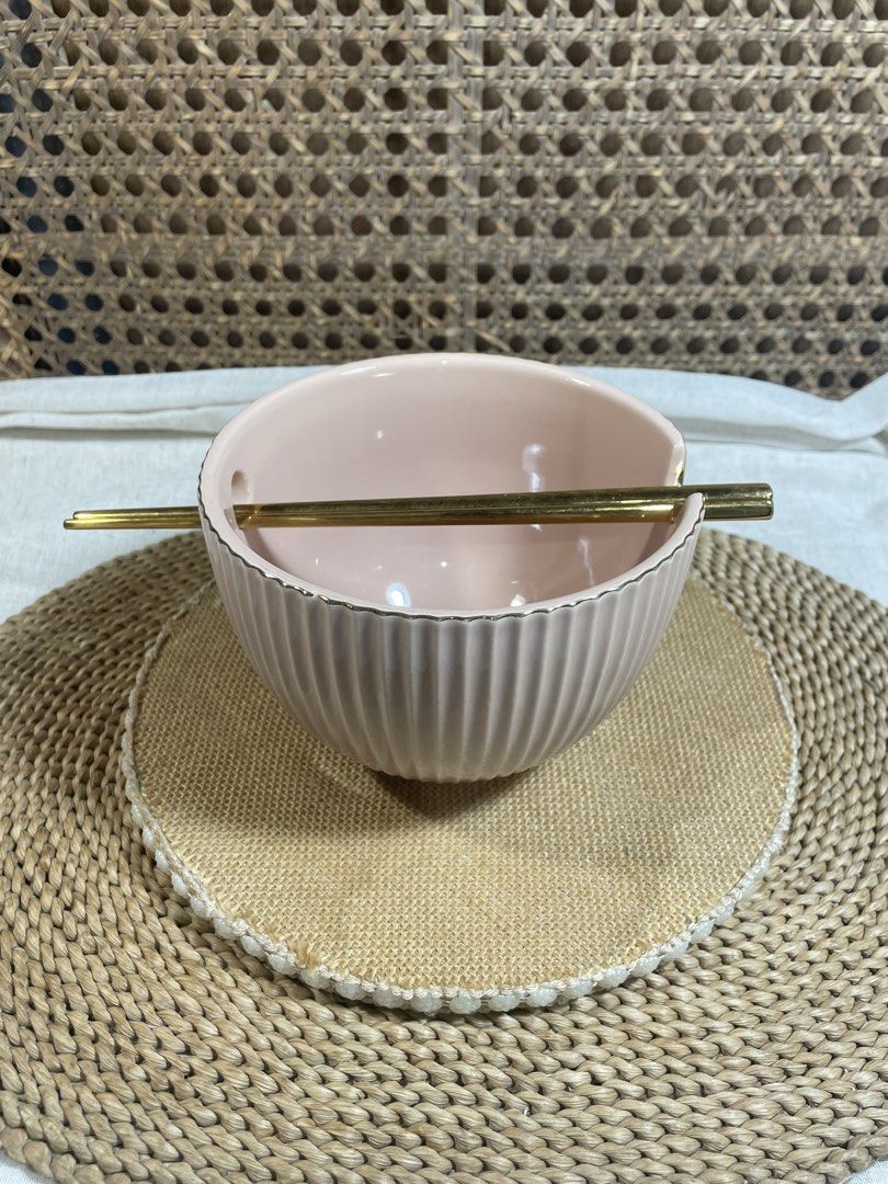 Pink Ceramic Ramen Bowl with Chopsticks (Category: Dinnerware & Cutlery) located in Quezon City. Submitted by 27ValiantStreet_Storefront (Listing ID 1424362823, Image 1). Description: Pink ceramic bowl comes with a pair of gold chopsticks. The bowl has a ribbed design and a small notch on the side for the chopsticks. Perfect as a ramen bowl. It has a diameter of approximately 6 inches and a height of about 3 inches. The chopsticks are gold in col