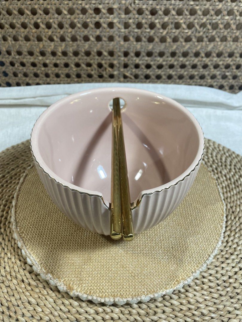 Pink Ceramic Ramen Bowl with Chopsticks (Category: Dinnerware & Cutlery) located in Quezon City. Submitted by 27ValiantStreet_Storefront (Listing ID 1424362823, Image 2). Description: Pink ceramic bowl comes with a pair of gold chopsticks. The bowl has a ribbed design and a small notch on the side for the chopsticks. Perfect as a ramen bowl. It has a diameter of approximately 6 inches and a height of about 3 inches. The chopsticks are gold in col