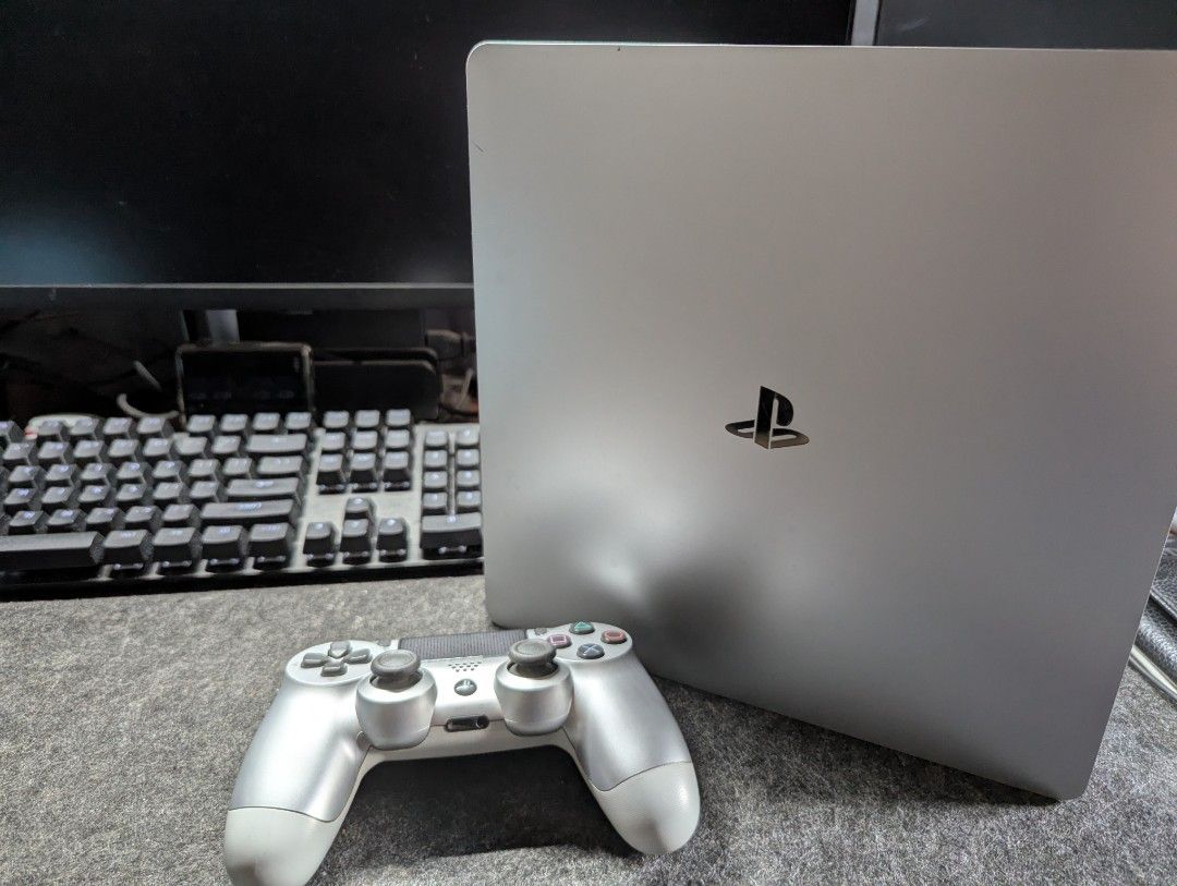 PlayStation 4 Silver Console (Category: PlayStation) located in Marikina City. Submitted by kpfinds (Listing ID 1424384056, Image 2). Description: - Silver PlayStation 4 console 500gb no issues some scratches comes with silver controller dobe stand hdmi cables will throw in 2 free games.