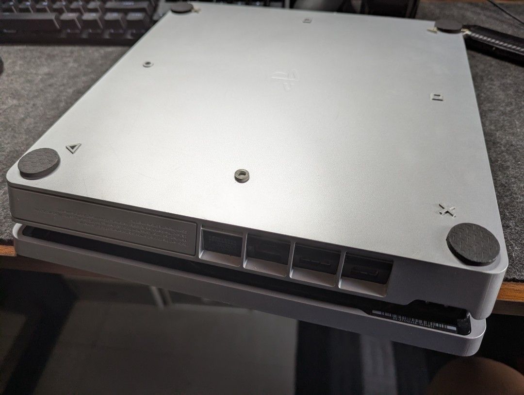 PlayStation 4 Silver Console (Category: PlayStation) located in Marikina City. Submitted by kpfinds (Listing ID 1424384056, Image 3). Description: - Silver PlayStation 4 console 500gb no issues some scratches comes with silver controller dobe stand hdmi cables will throw in 2 free games.