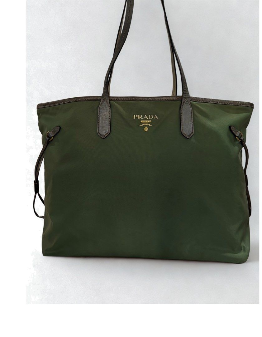 Prada Nylon Tote Bag (Category: Luxury Bags & Wallets) located in Paranaque City. Submitted by katlouieleandicho (Listing ID 1424413448, Image 2). Description: - 💯Authentic Prada tote bag - Green nylon exterior - Leather handles and trim - Drawstring closure - Gold Prada logo - Spacious design - Suitable for everyday use .