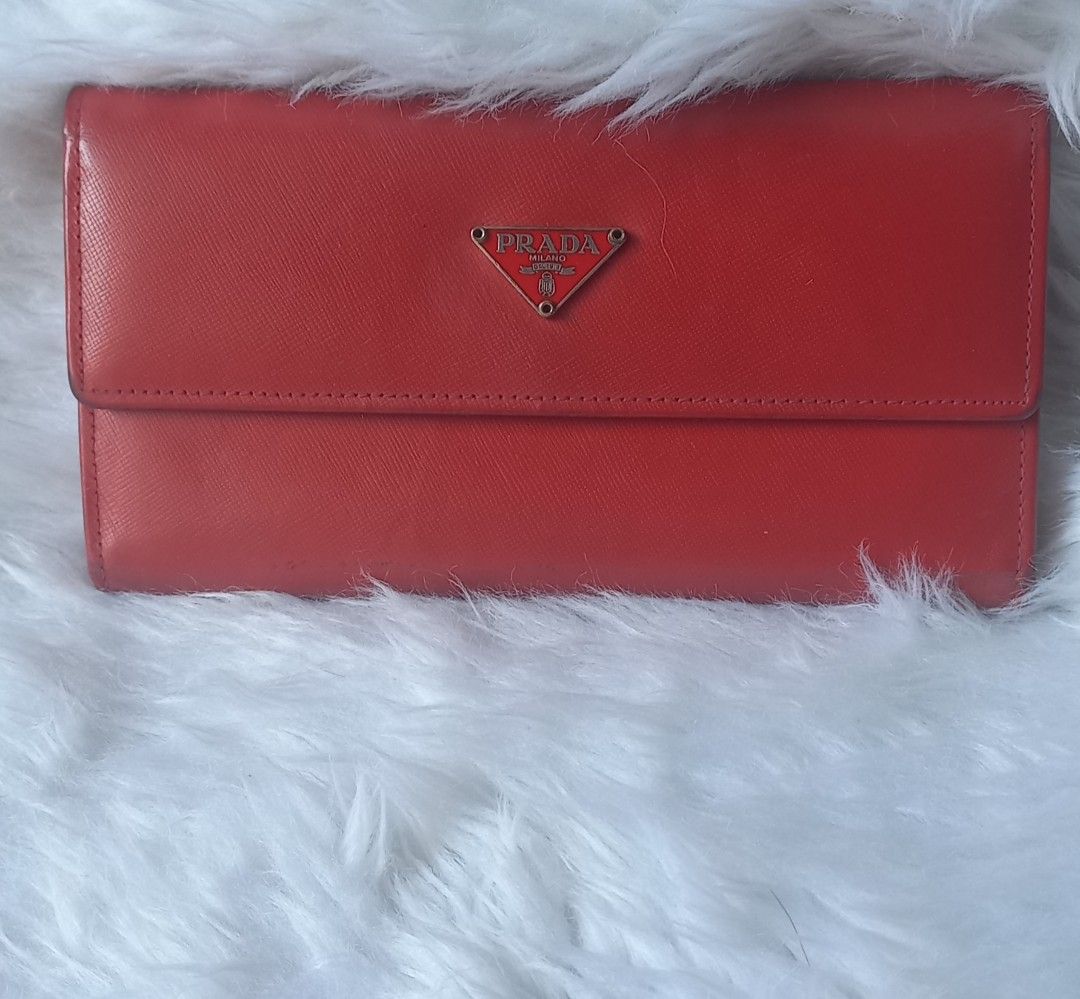 PRADA Red Tripold wallet (Category: Luxury Bags & Wallets) located in Valenzuela. Submitted by cc850906 (Listing ID 1424425503, Image 1). Description: - Prada red leather wallet - Flap closure - Prada logo on front - Smooth leather material - Long wallet style - Vibrant red color - Perfect for cards, cash, and essentials discount for sure buyer🥰.