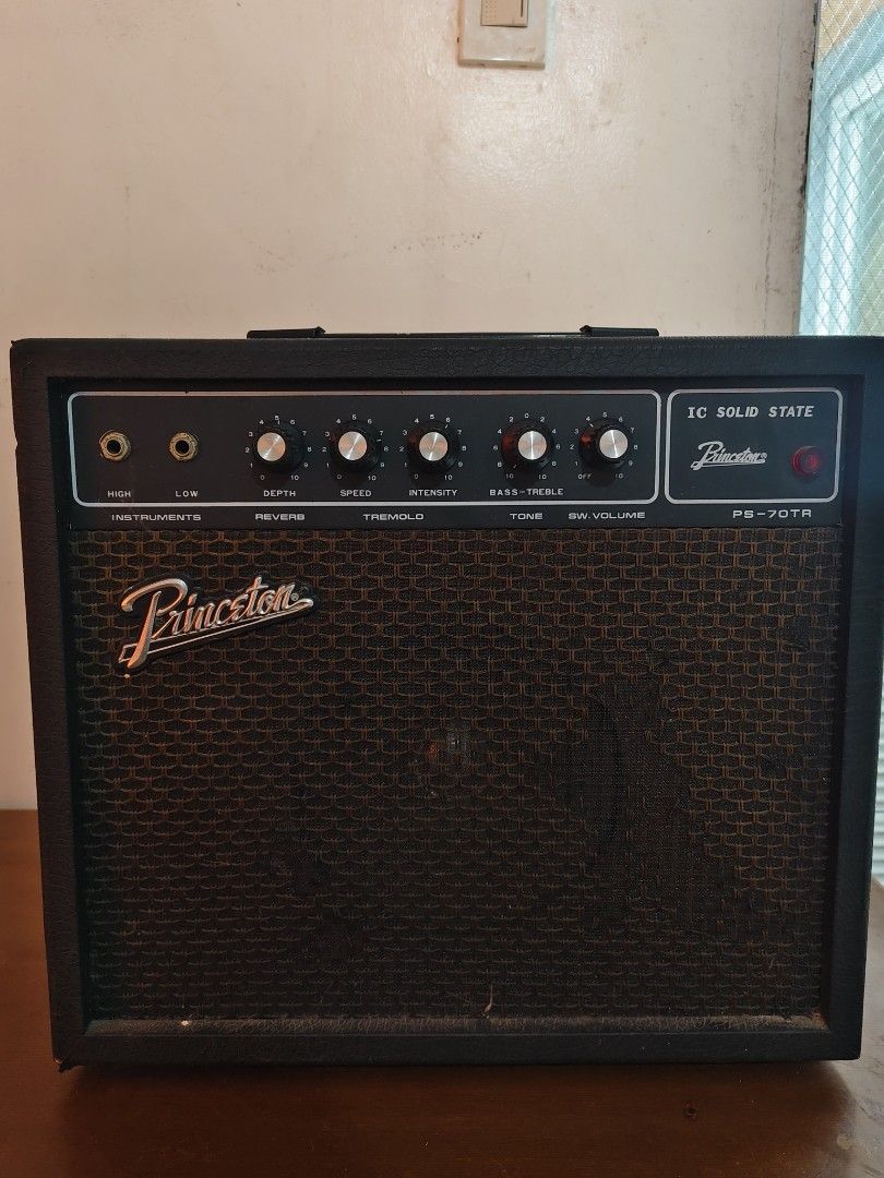 Princeton PS-70TR IC Solid State Guitar Amplifier (Category: Musical Instruments) located in Bulacan. Submitted by babz30261 (Listing ID 1424394936, Image 1). Description: Princeton PS-70TR guitar amplifier. Features include high and low instrument inputs, depth, speed, intensity, bass-treble, and volume controls. It has a tremolo effect. The back panel has ventilation slots and a power cord. The amplifier is black with a brown speaker grill..