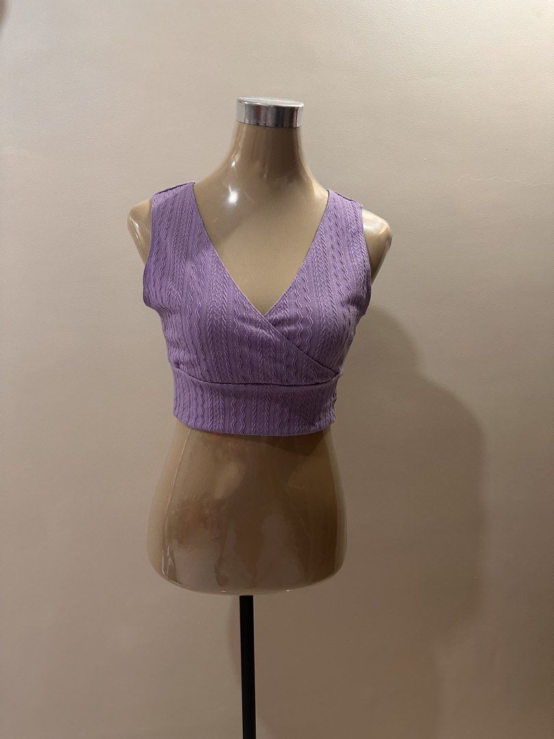 Purple Crop Top (Category: Sleeveless) located in San Fernando. Submitted by rpam21 (Listing ID 1424382102, Image 1). Description: - V-neck crop top - Textured fabric - Wrap-style front - Fitted silhouette - Sleeveless design - Lightweight material - Solid purple color.