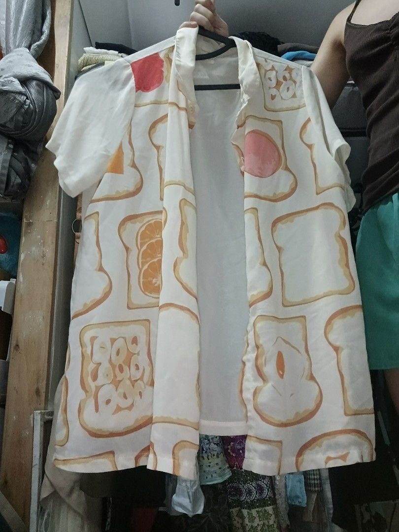 Sheer Polo Bread Design (Category: Coats, Jackets and Outerwear) located in Manila. Submitted by nomiseyer (Listing ID 1424364191, Image 2). Description: - Unique polo with a playful bread and fruit print. - Features short sleeves and an open front. - Made from lightweight fabric, ideal for layering. - Adds a fun touch to any outfit..