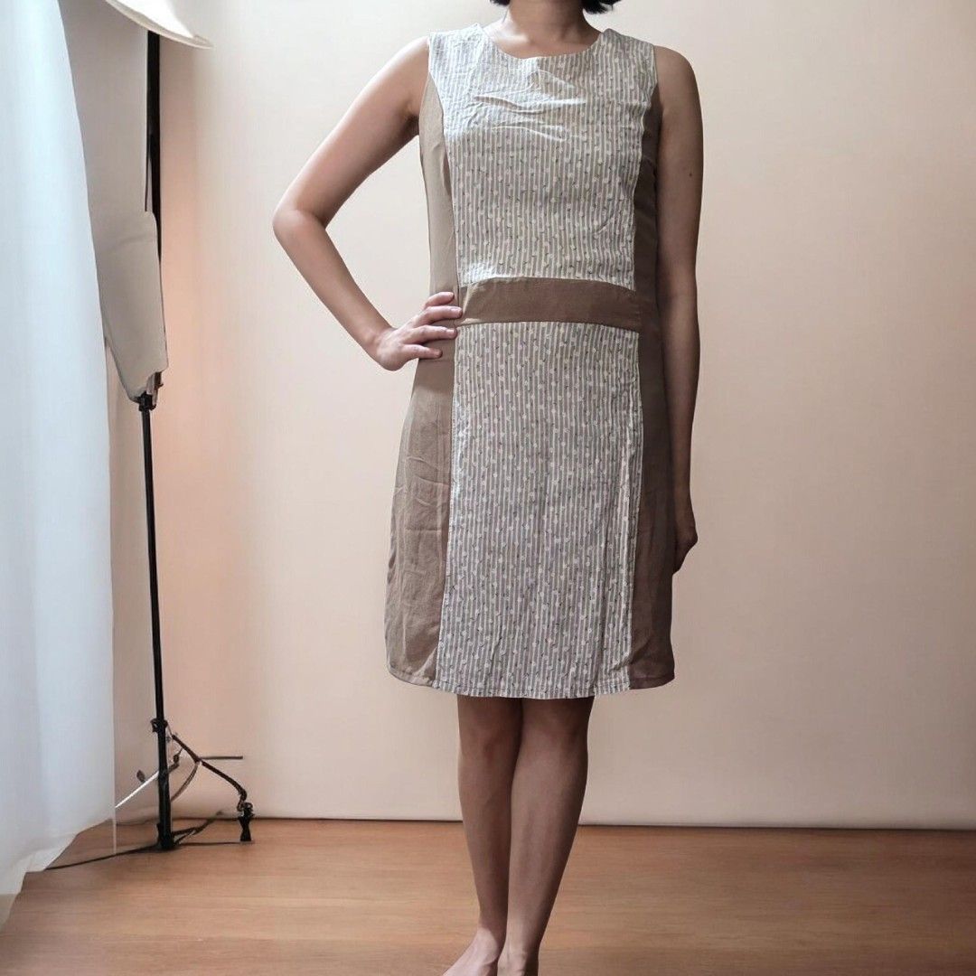 Sleeveless Dress with Striped Panel (Category: Dresses) located in Quezon City. Submitted by highonspotlight (Listing ID 1424509290, Image 1). Description: Sleeveless dress features a unique design with a striped panel in the center. It has a brown band at the waist and is knee-length. It's a simple yet stylish piece that can be dressed up or down. fits XS to S frames.