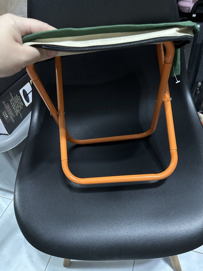 Snoopy Beagle Scouts Folding Stool (Category: Chairs) located in Manila. Submitted by krystalchewey_ (Listing ID 1424494182, Image 2). Description: Snoopy Beagle Scouts folding stool is perfect for outdoor adventures. It features a Snoopy design and a compact, foldable design for easy storage and transport. The stool has an orange metal frame and a beige fabric seat with a green border. It comes with a matching carrying case. Great for camping, p