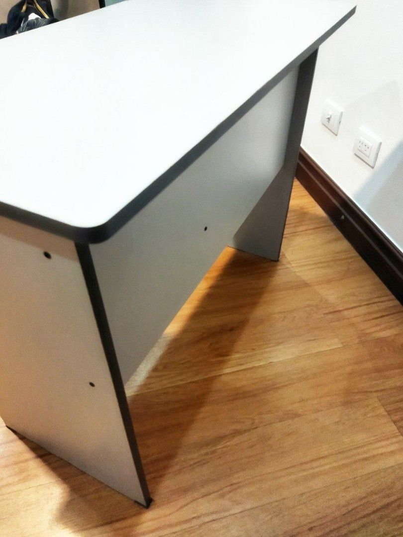 Study Desk with Drawer (Category: Tables & Sets) located in Taguig. Submitted by ohhhs (Listing ID 1424468803, Image 2). Description: - Study desk with white top and gray frame - Includes a lockable drawer with key - Features a small compartment - Ideal for studying or home office use - Minor wear and tear on one corner.