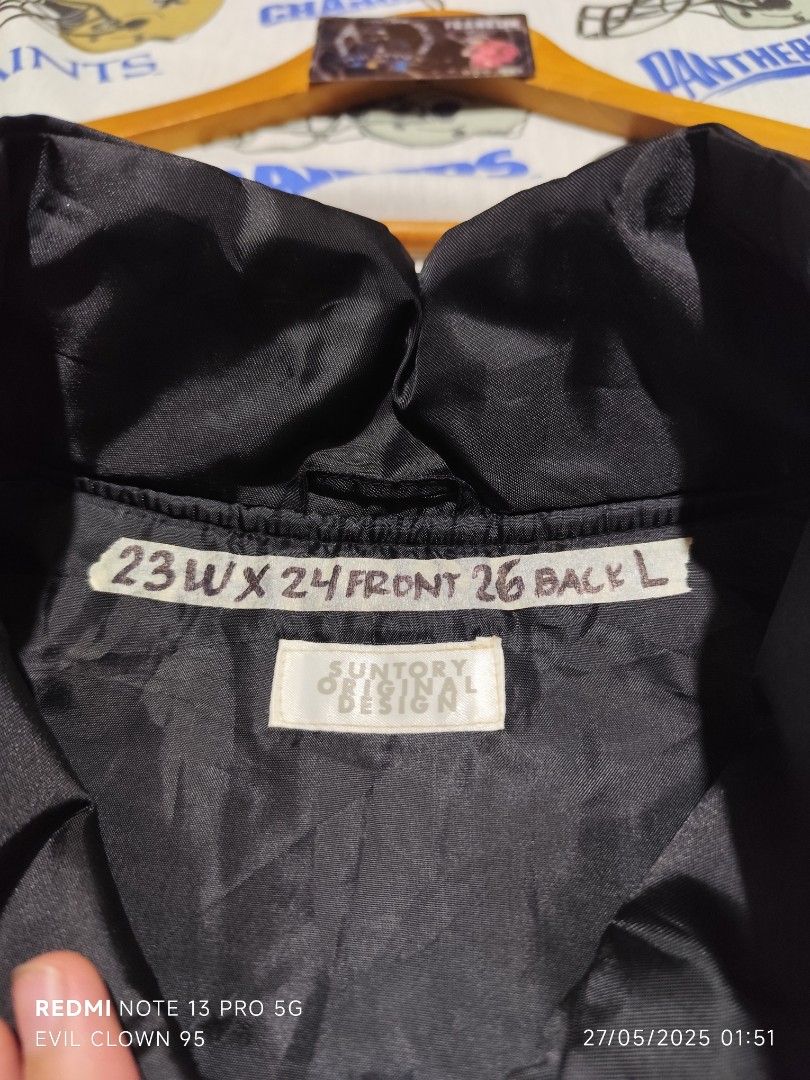 Suntory Malt's Vest - Black (Category: Vests) located in Baguio. Submitted by FRANKLIN (Listing ID 1424472915, Image 3). Description: Black vest with Suntory Malt's logo. Features a zip-up front, two front pockets, and a small pocket on the chest. The vest has a collar and is labeled as size L. Measurements are 23W x 24 Front x 26 Back. Made with 100% nylon and polyester..