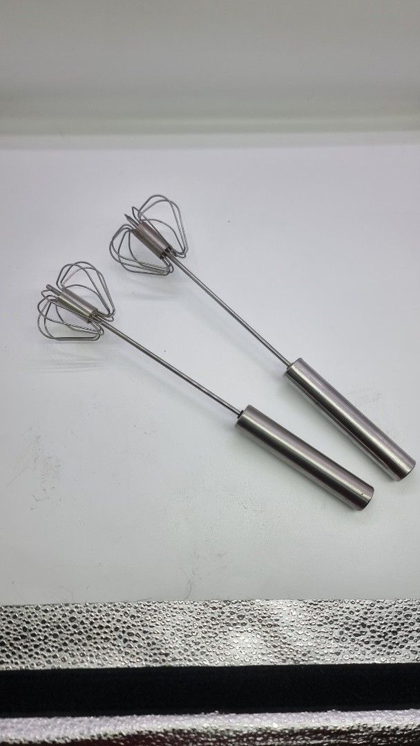 Take all Stainless Steel Whisk (Category: Bakeware) located in Marikina City. Submitted by andreah_16 (Listing ID 1424354789, Image 2). Description: Listing is for a pair of stainless steel whisks. They have a simple design with a wire whisk head and a cylindrical handle. The whisks appear to be made of stainless steel. They are suitable for mixing ingredients in the kitchen..
