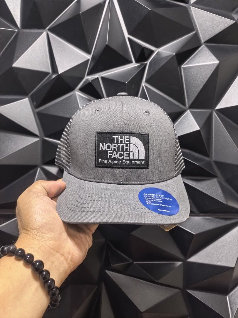The North Face Classic Fit Trucker Cap (Category: Caps & Hats) located in Bacoor. Submitted by secretsup (Listing ID 1424456493, Image 2). Description: North Face Classic Fit Trucker Cap. Features a classic trucker design with a mesh back for breathability. The front panel displays The North Face logo. Available in multiple colors. Includes the original tag..