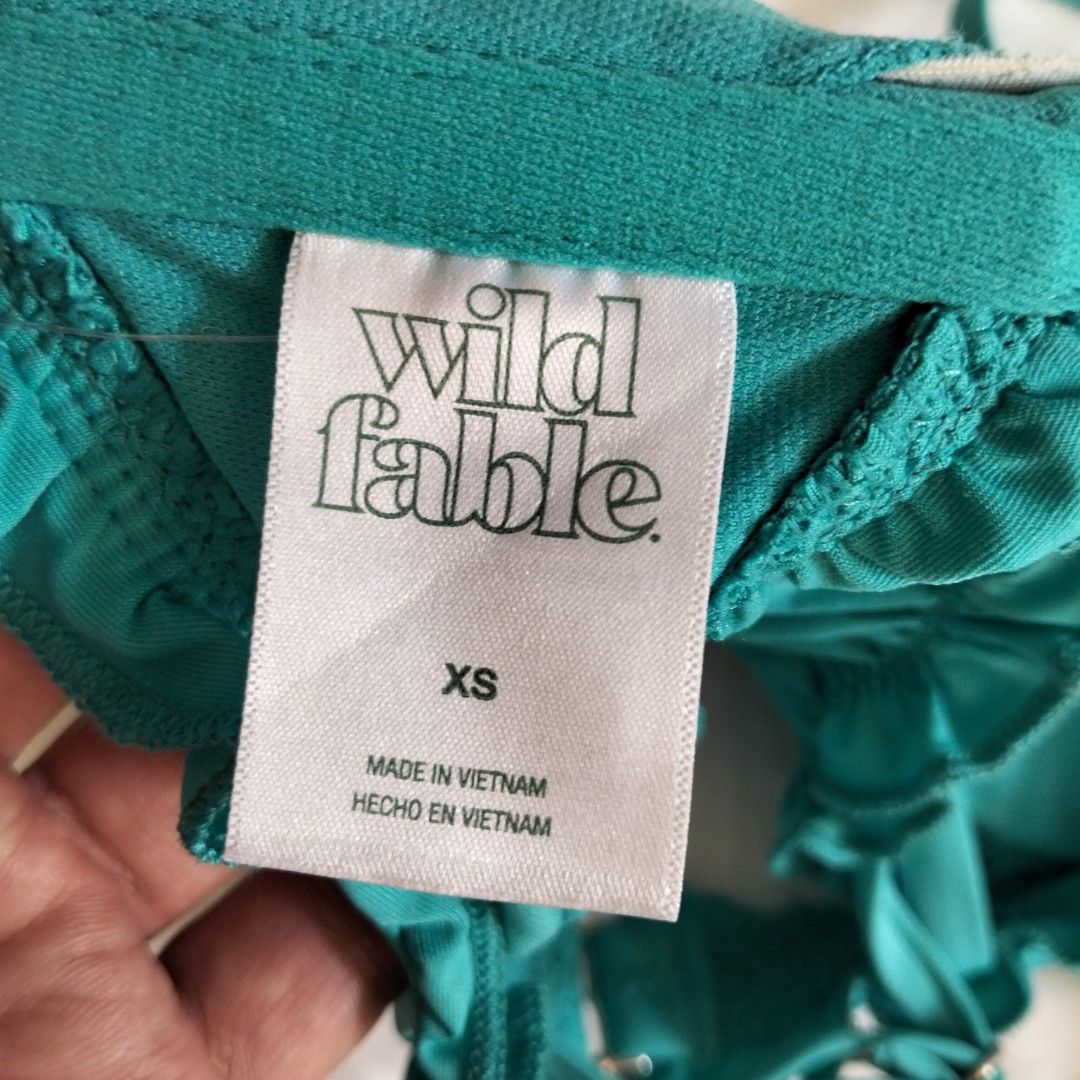 Wild Fable Ruffle Bikini Top XS (Category: Bikinis & Swimsuits) located in Quezon City. Submitted by heybailey (Listing ID 1424435981, Image 3). Description: - Wild Fable bikini top - Vibrant teal color - Ruffle design - Adjustable straps - Clasp closure - Size: XS - Made in Vietnam.